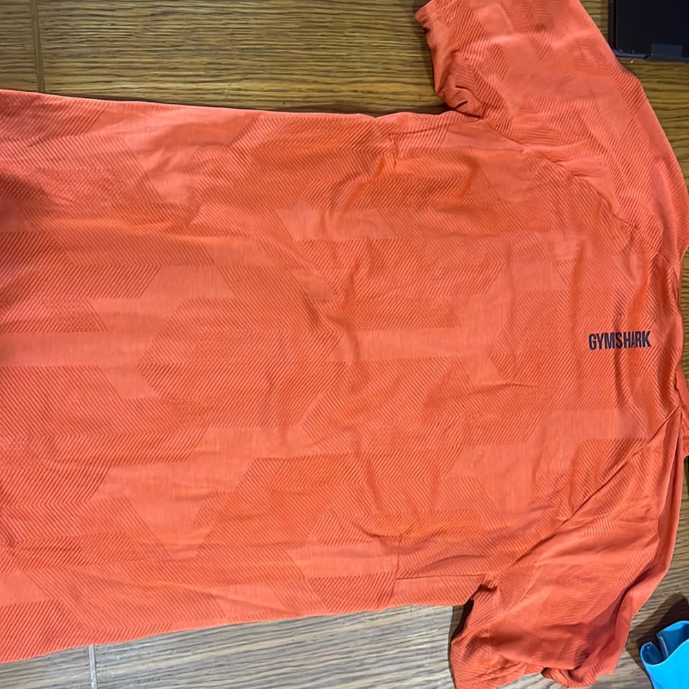 Used Orange Gymshark shirt.  Size Medium.  Good condition.